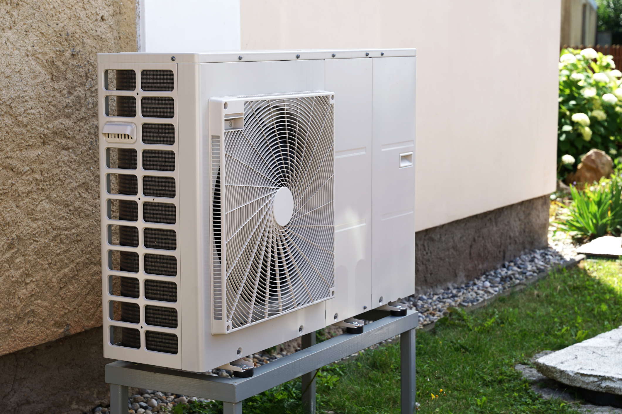 Air-source heat pump against an exterior house wall